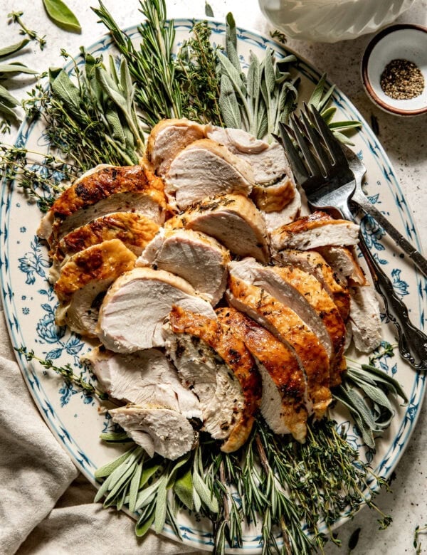 Overhead view roasted turkey breast sliced and served on platter