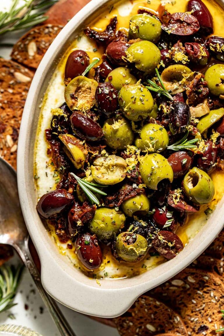 Whipped Feta Dip with Roasted Olives topped with fresh thyme. 