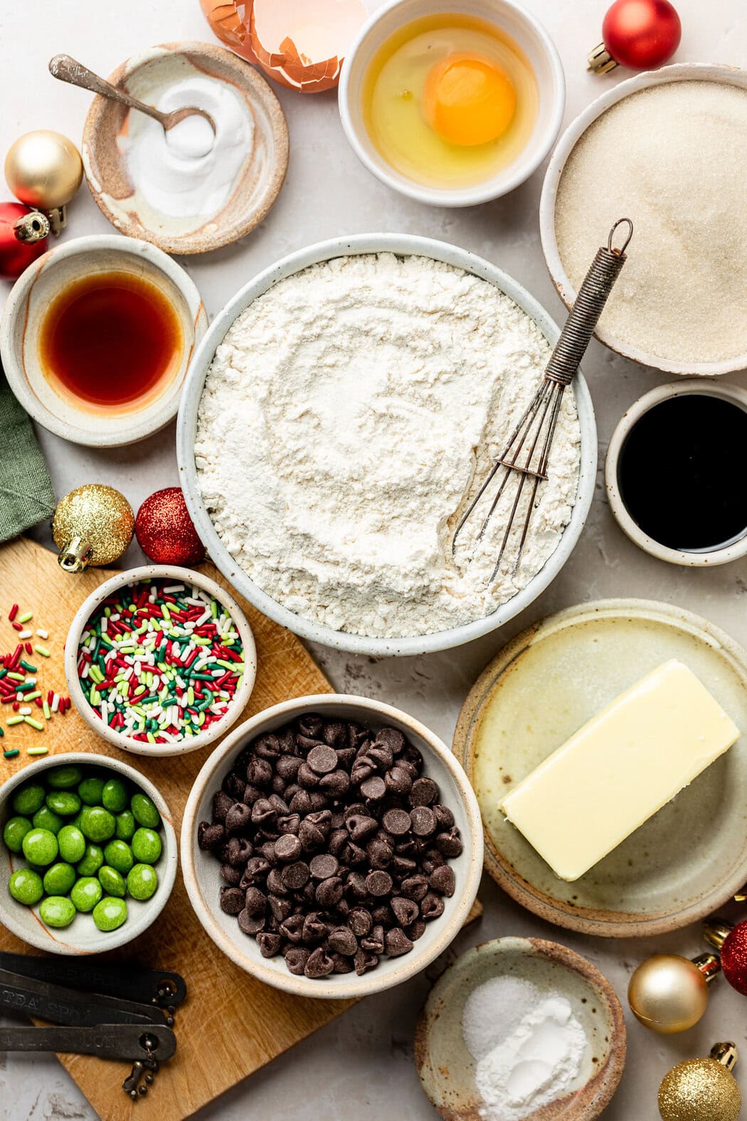 Overhead view of a variety of ingredients for Ana’s Christmas Cookies in different sized bowls. 