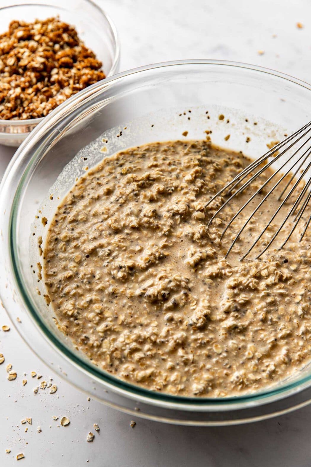 Glass bowl of Cinnamon Streusel-Topped Baked Oatmeal batter ready to be added to a baking dish. 