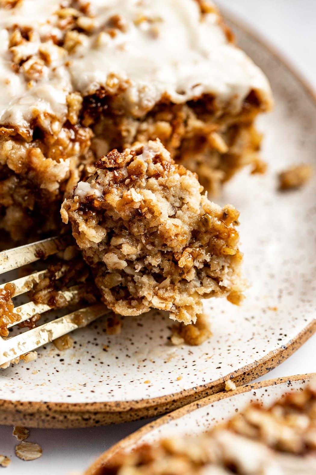 A close-up view of a bite of Cinnamon Streusel-Topped Baked Oatmeal on a fork. 