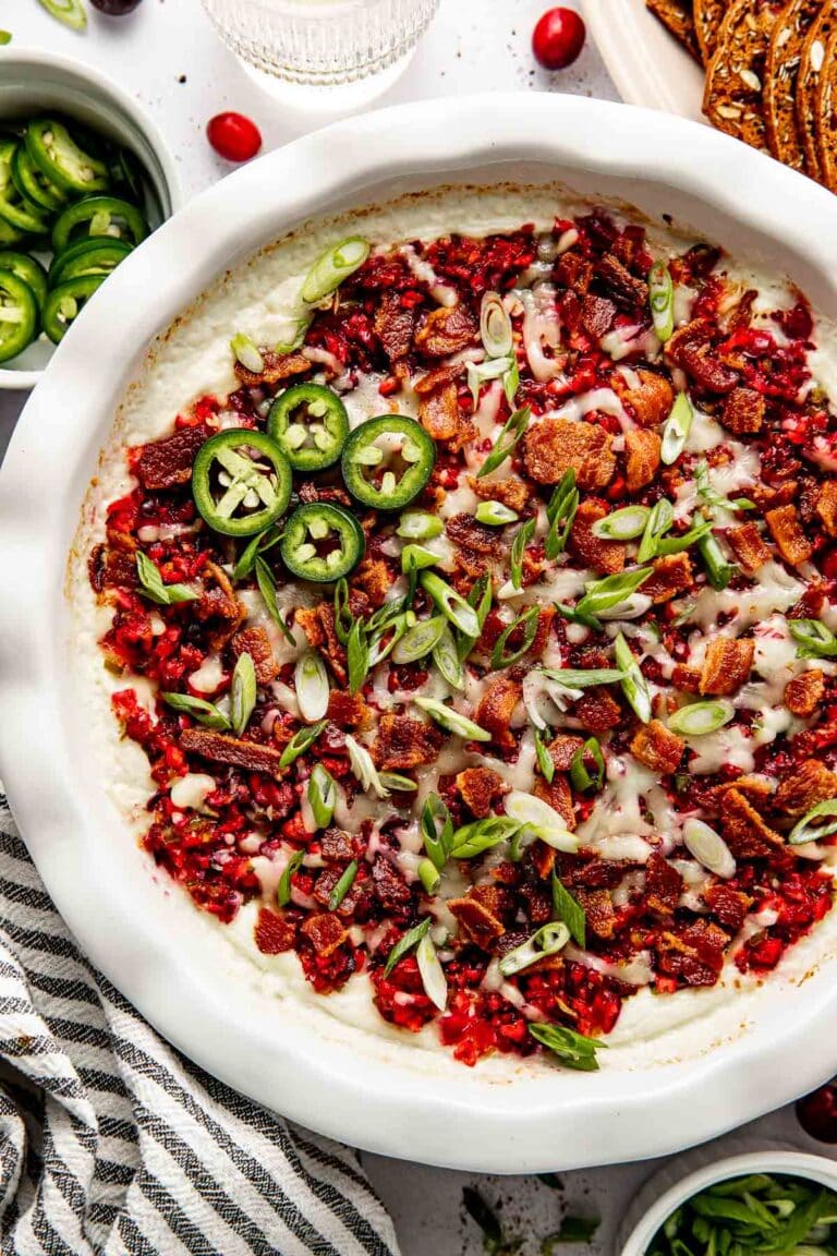 Freshly baked cranberry jalapeno dip topped with crisp bacon pieces and green onions. 