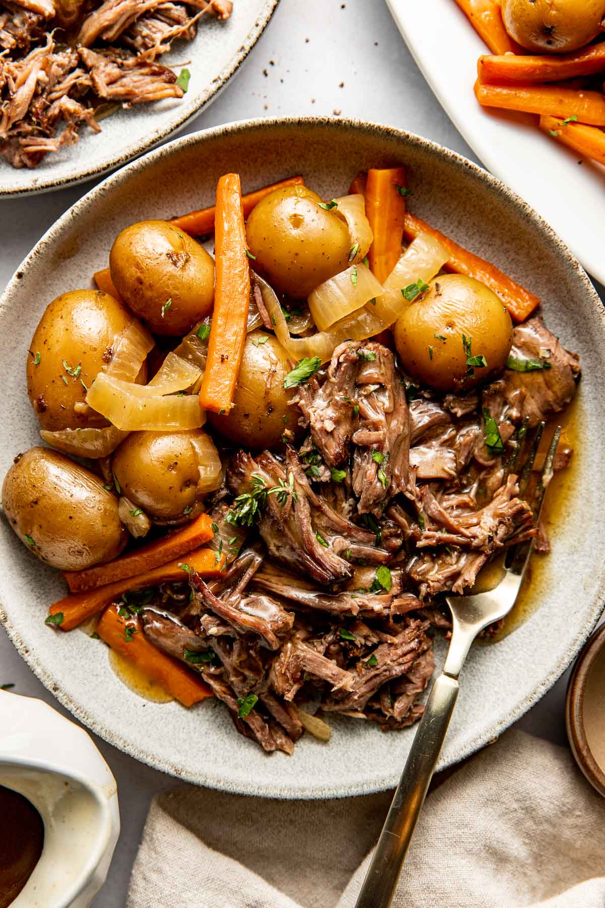 Overhead view of a plate of Slow Cooker Pot Roast with potatoes and carrots. 