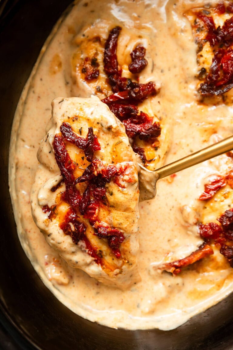 Overhead view of a slow cooker filled with Marry Me Chicken. 