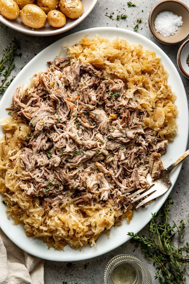 pork & sauerkraut on a platter with a fork on the side. 
