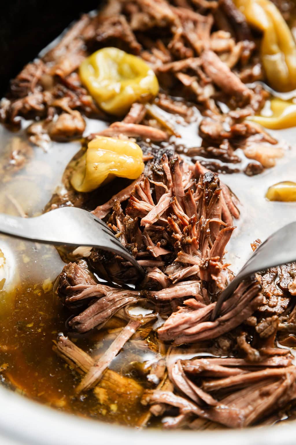 Close up view of a fork filled with Slow Cooker Mississippi Pot Roast. 