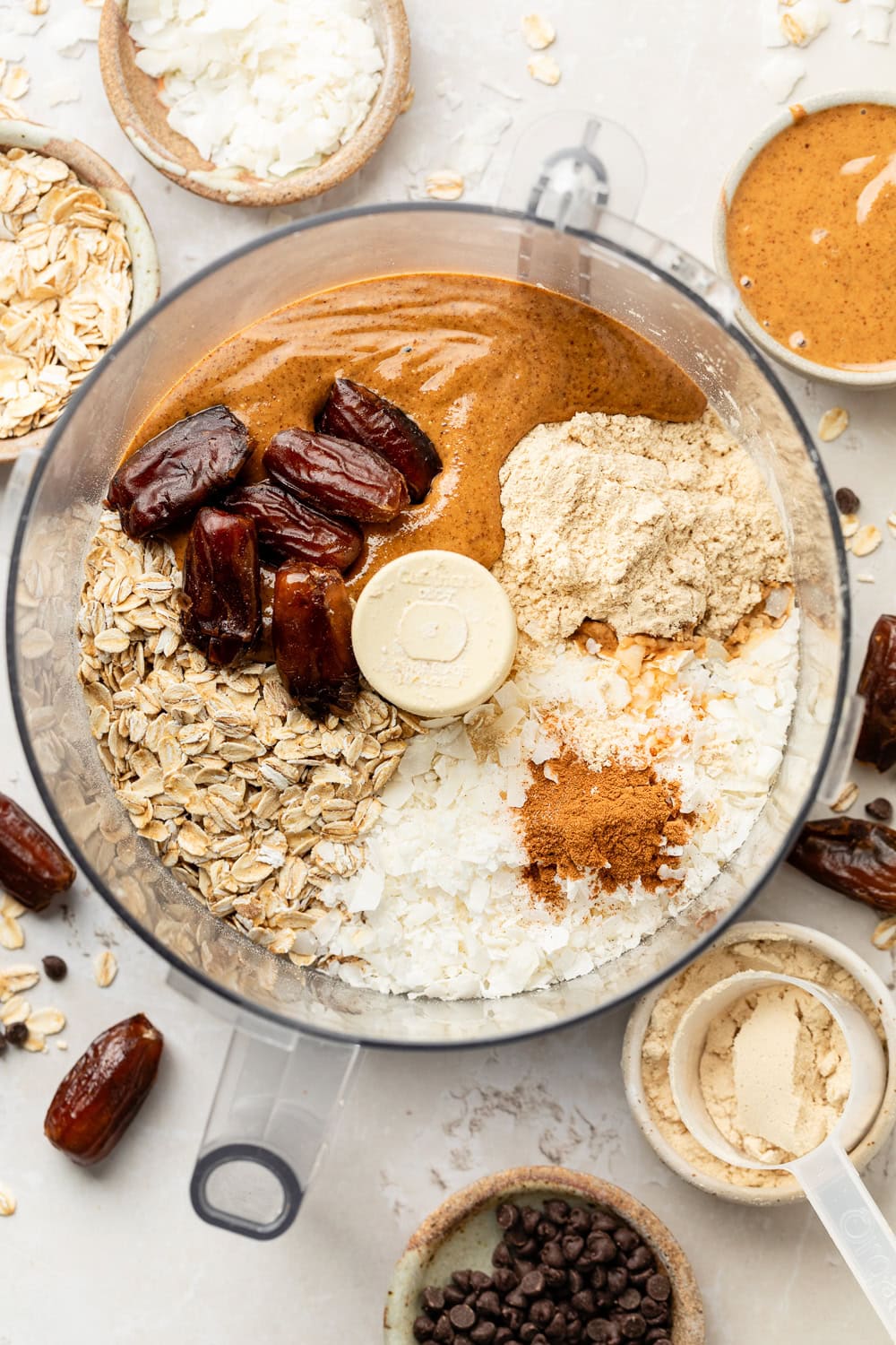 Overhead view of Almond Butter Protein Balls ingredients in a food processor ready to be blended. 