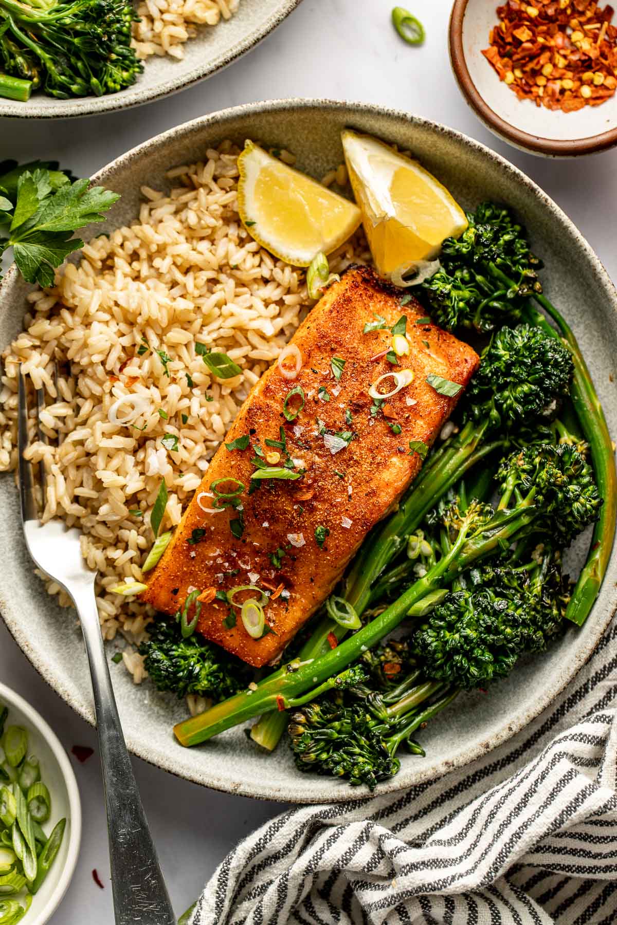 Overhead view of a plate of Air Fryer Salmon on top of rice and a side of broccolini. 