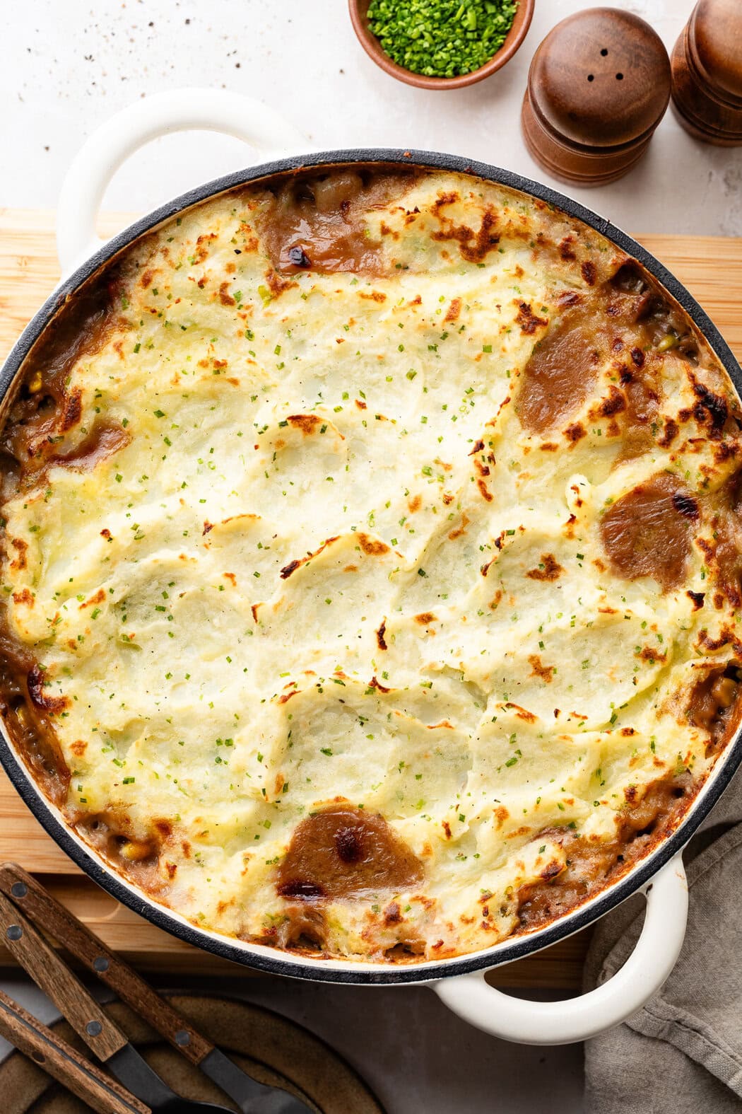 Overhead view of a skillet filled with freshly baked Cottage Pie With Garlic Mashed Potatoes.