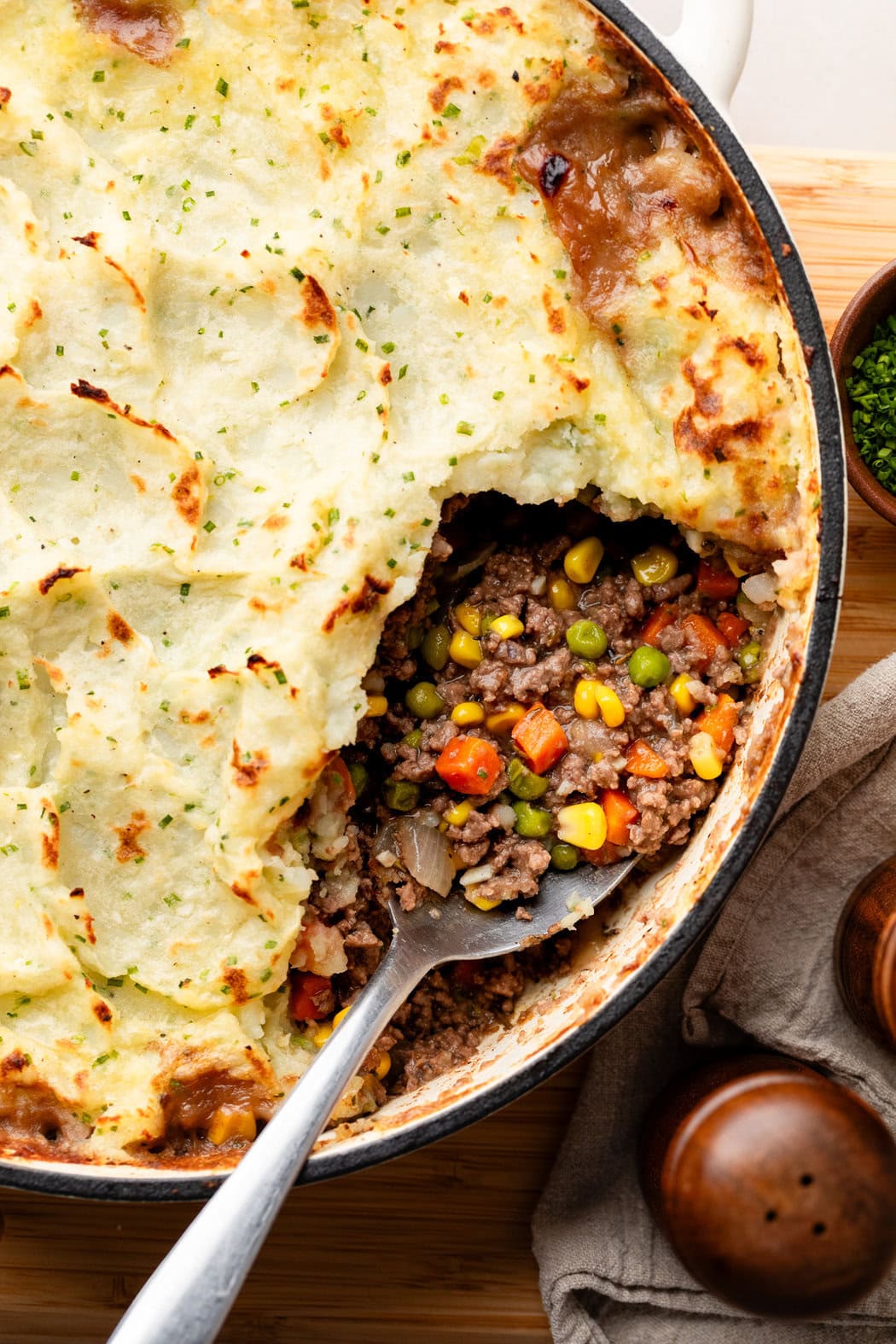 Close up view of a skillet filled with Cottage Pie With Garlic Mashed Potatoes. 