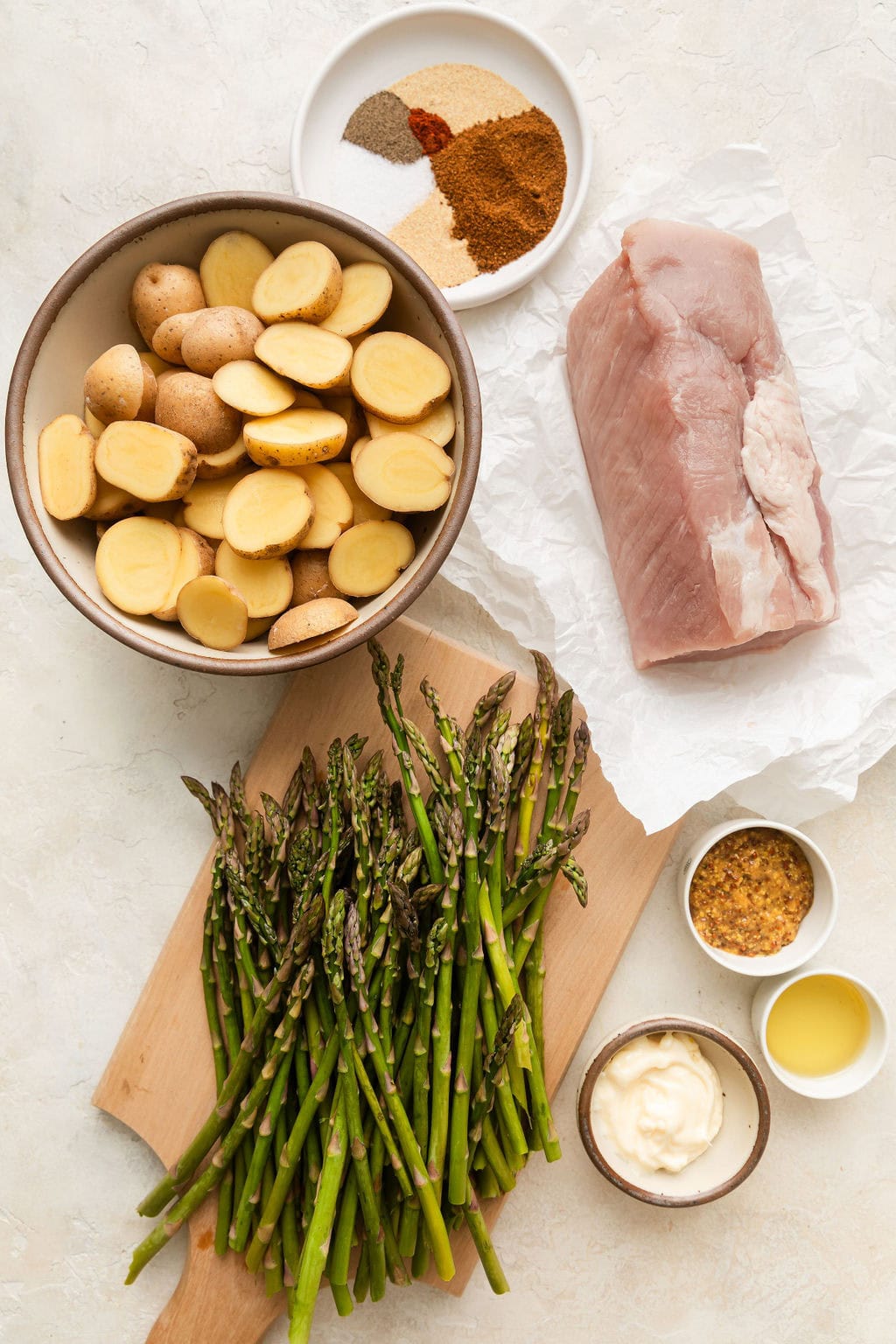 Overhead view of a variety of ingredients for Sheet Pan Pork Tenderloin. 