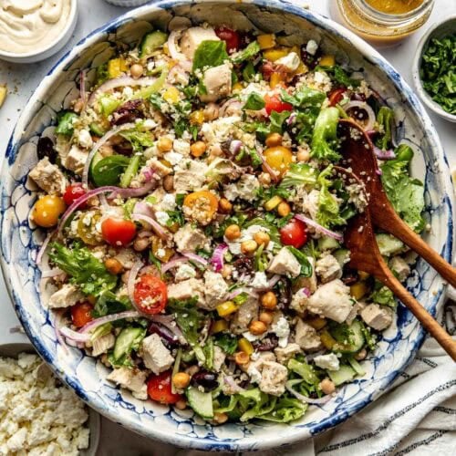 Overhead view large serving bowl filled with chopped Mediterranean Salad with chicken and chickpeas