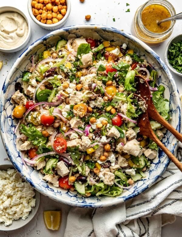 Overhead view large serving bowl filled with chopped Mediterranean Salad with chicken and chickpeas