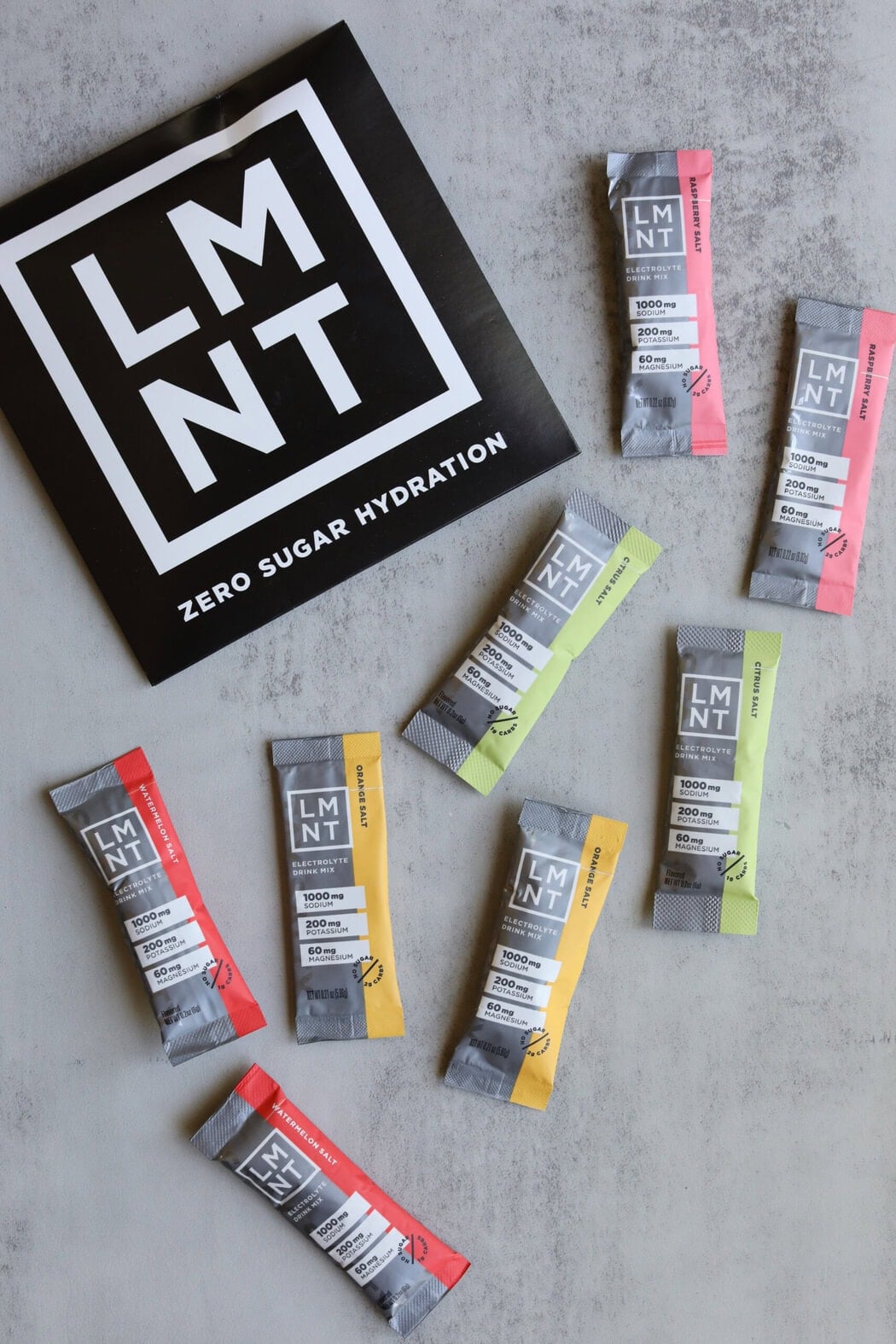 Overhead shot of an LMNT sample pack containing 2 sticks each of Raspberry, Watermelon, Orange, and Citrus Salt flavors.