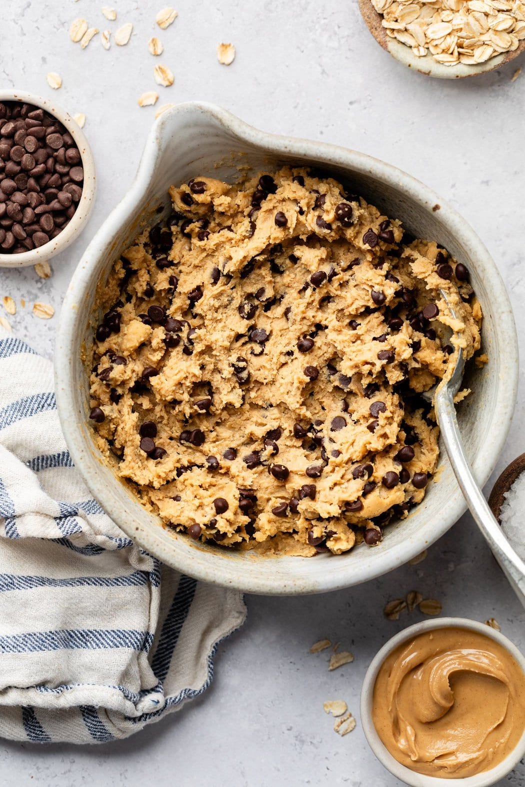Overhead view of a mixing bowl filled with Chickpea Cookie Dough topped with chocolate chips