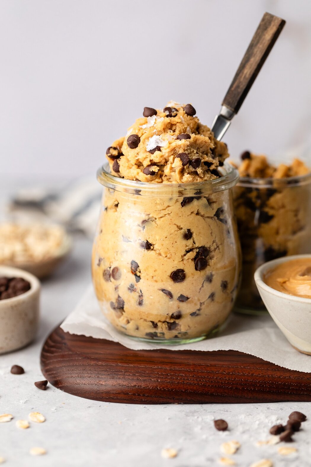 Side view of a glass jar of Chickpea Cookie Dough topped with flakey sea salt