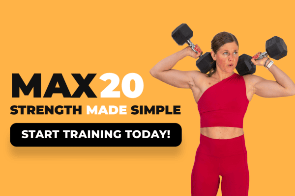A woman in workout clothes holding two dumbbells overhead.