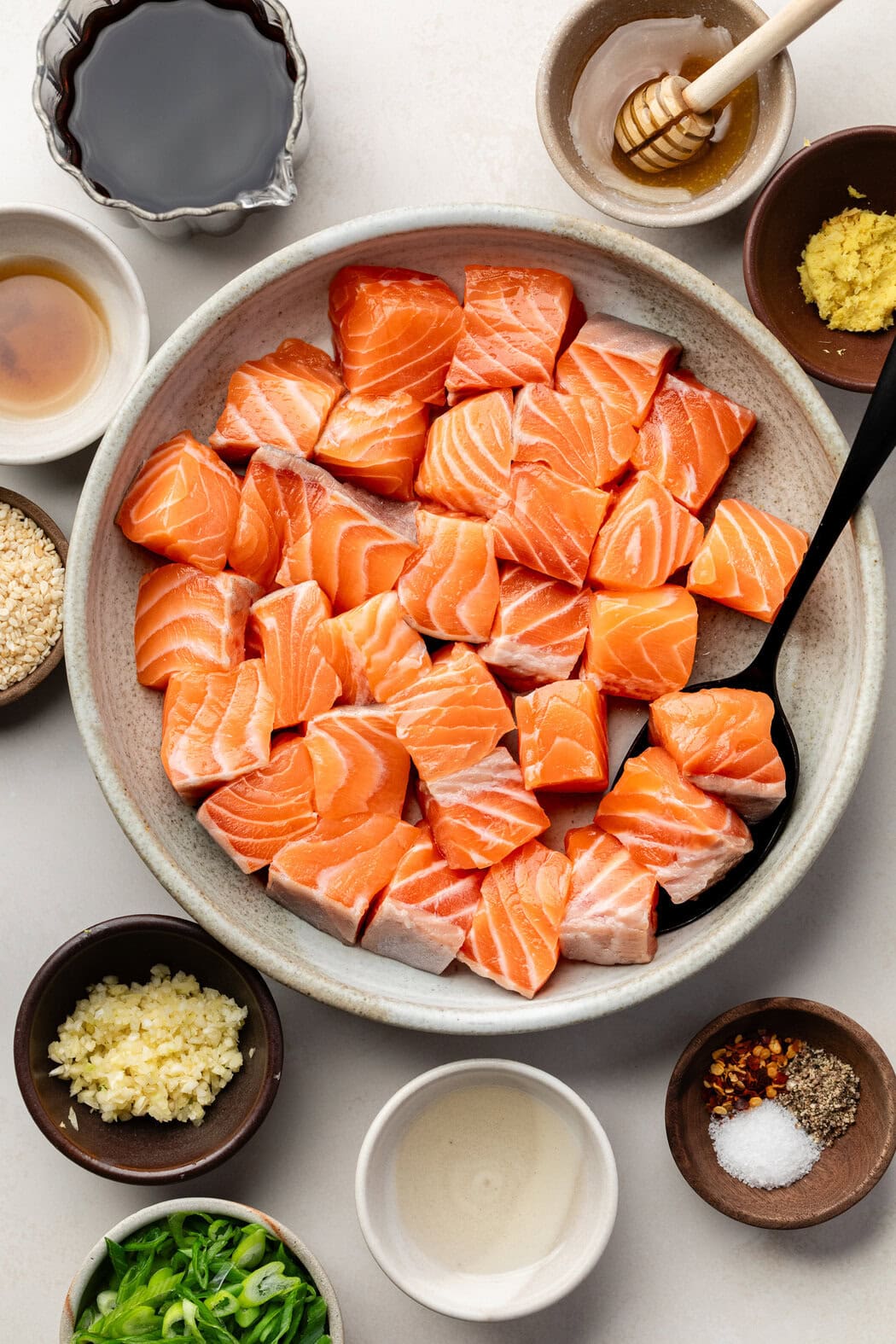 Overhead view of a variety of ingredients for Air Fryer Salmon Bites in different sized bowls.
