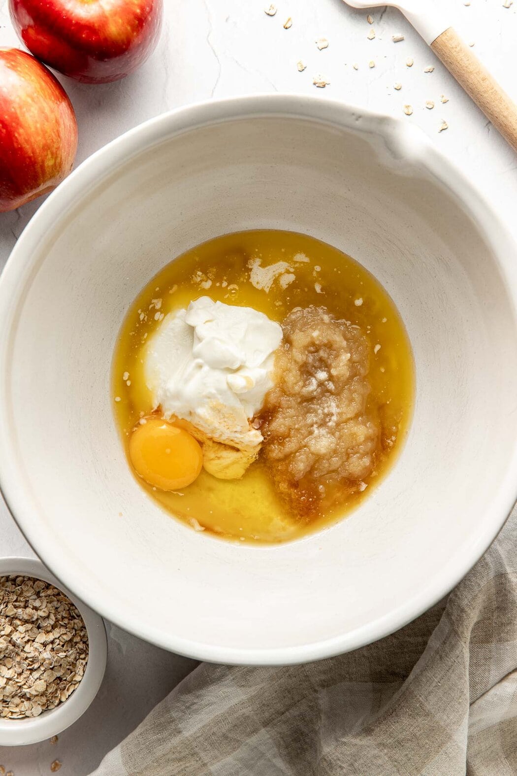 Overhead view of a bowl of wet ingredients for Apple Cinnamon Protein Muffins ready for mixing. 