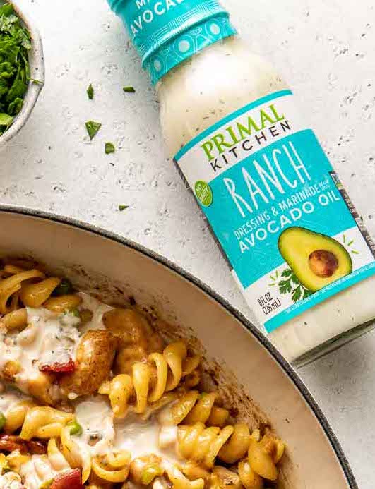 Overhead view of a glass bottle of primal kitchen ranch dressing