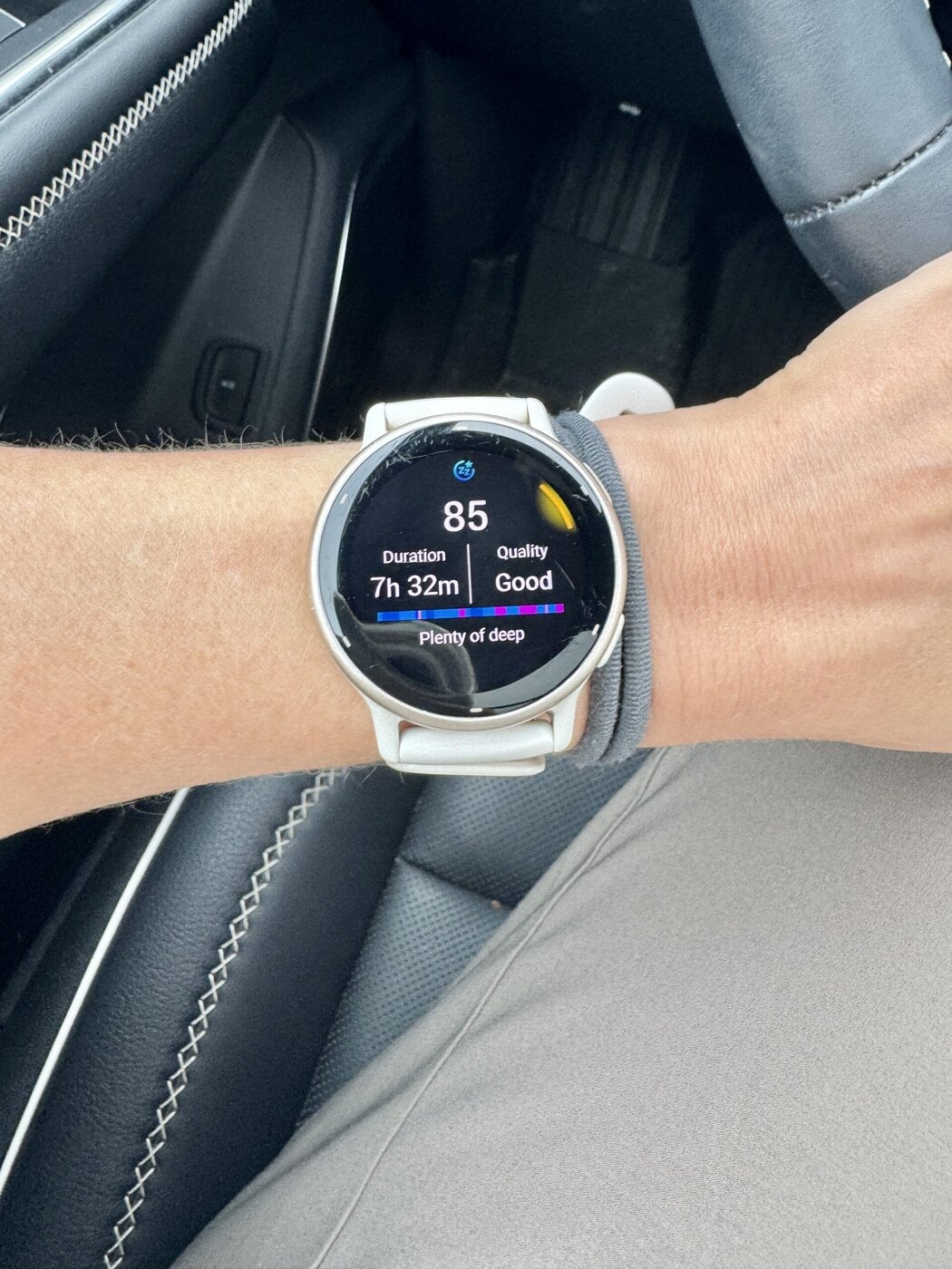 A womans wrist showing her watching and sleep score. 