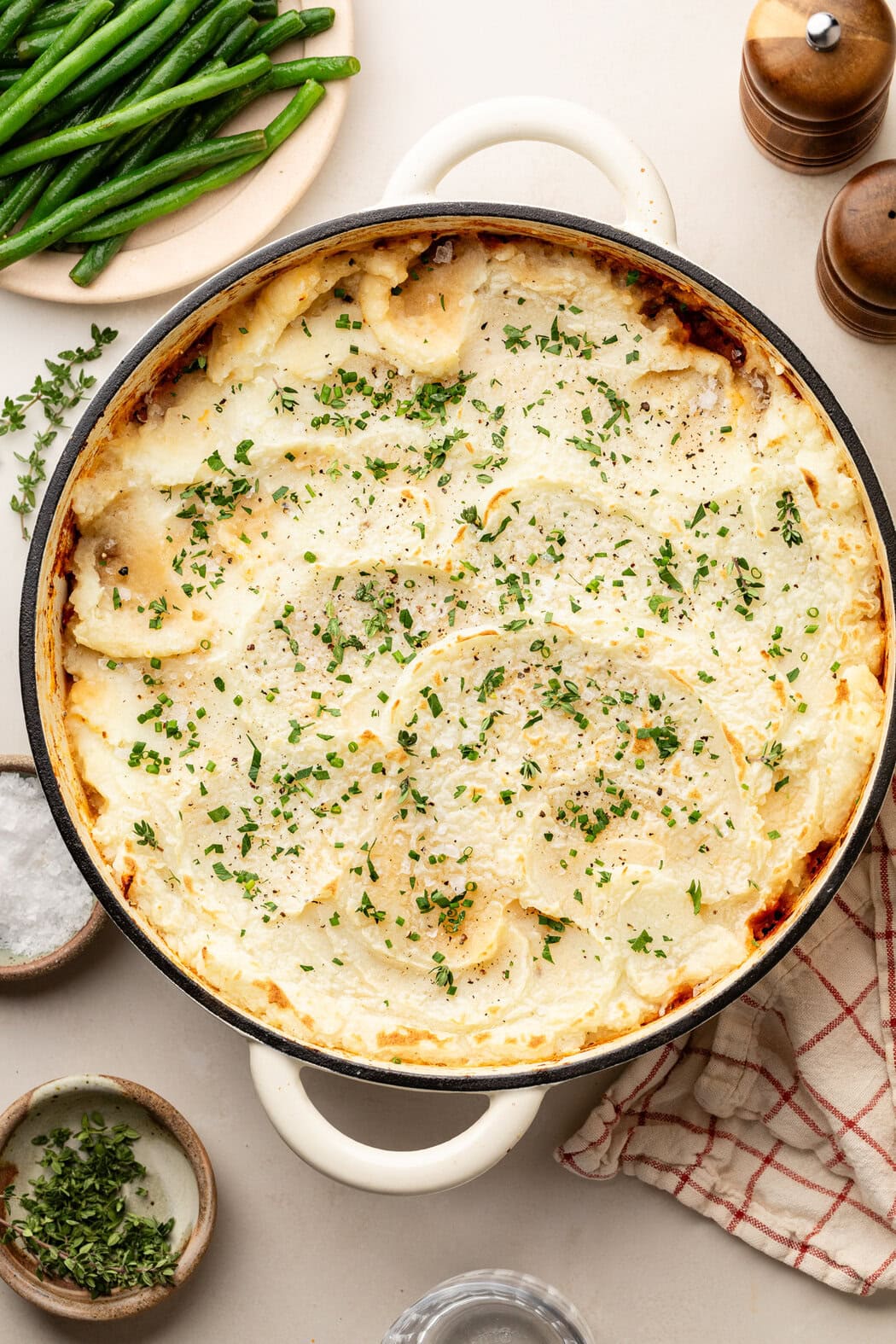 Overhead view of a skillet filled with freshly baked Sloppy Joe Casserole topped with fresh herbs. 