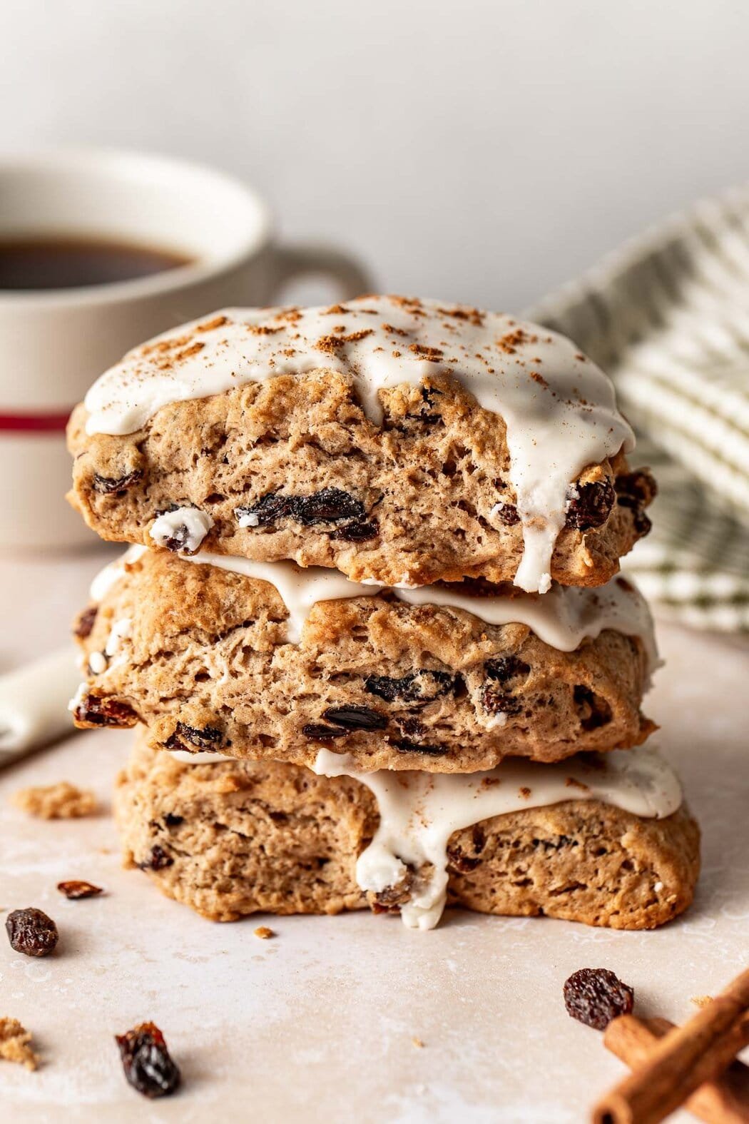 Close up view of a stack of freshly glazed Cinnamon Raisin Biscuits. 
