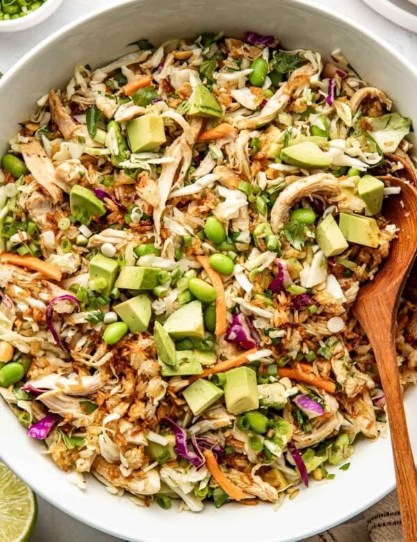 Overhead view of a bowl filled with crispy rice salad with fresh vegetables and topped with edamame.