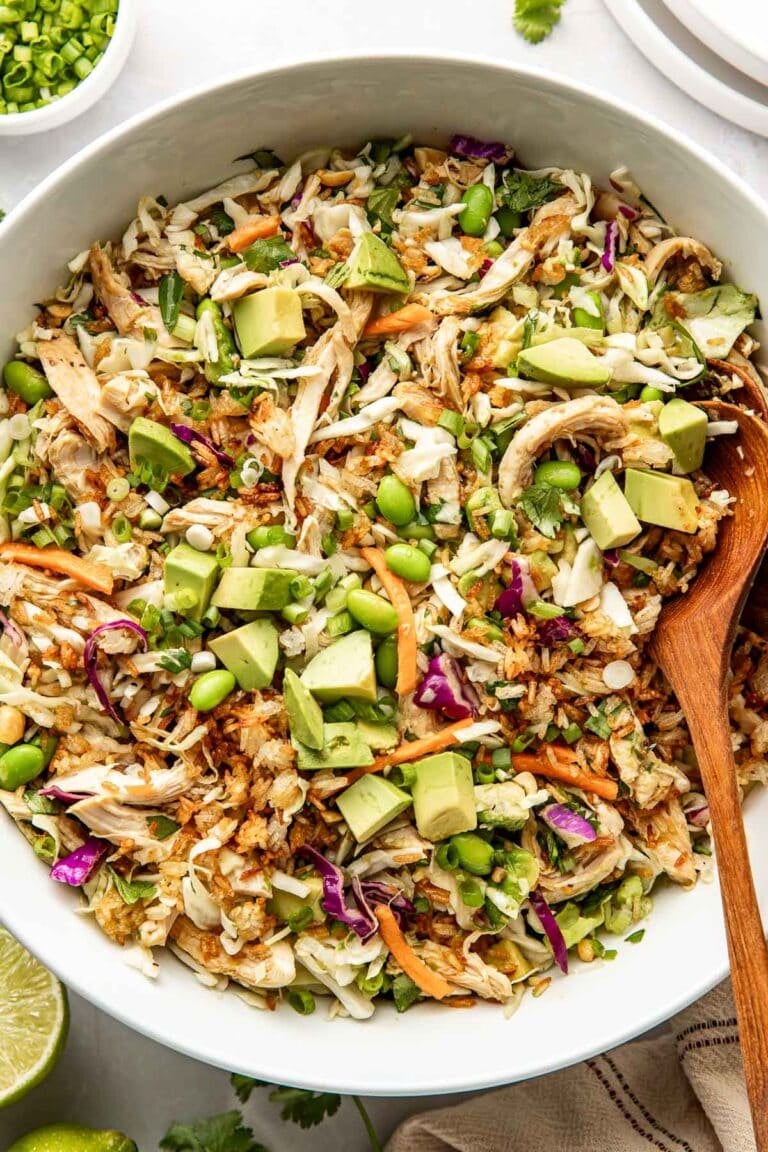 Overhead view of a bowl filled with crispy rice salad with fresh vegetables and topped with edamame.