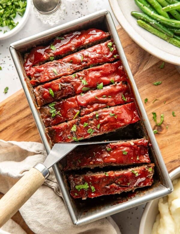 A loaf pan filled with slices of meatloaf