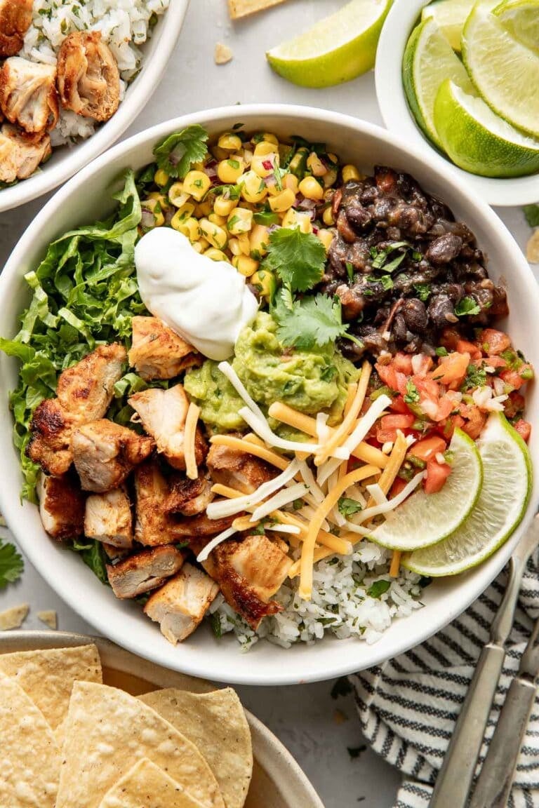 Overhead view of a Chicken Chipotle bowl with rice, corn, beans and a dollop of sour cream.