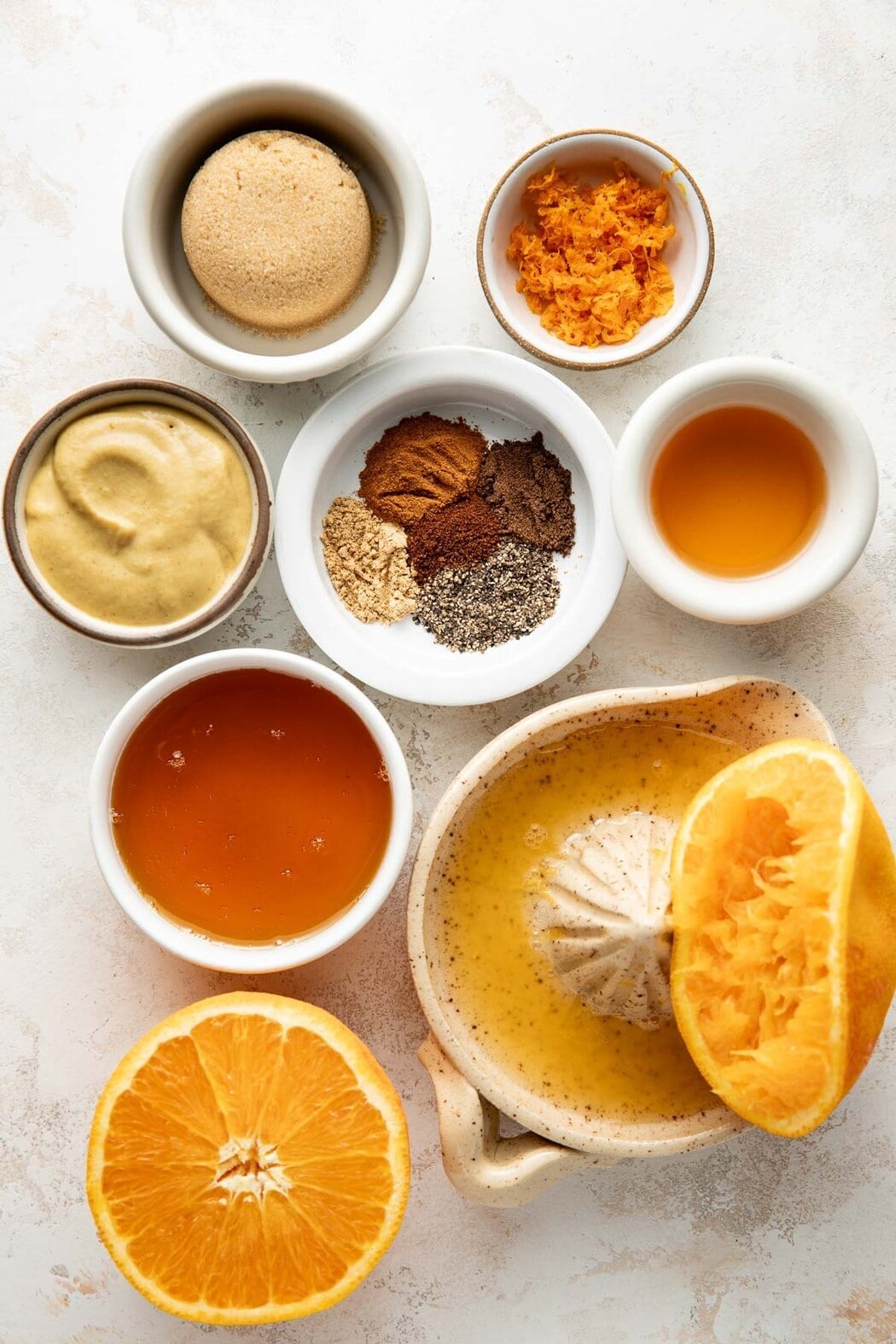 Overhead view of a variety of ingredients for Ham Glaze in different sized bowls.