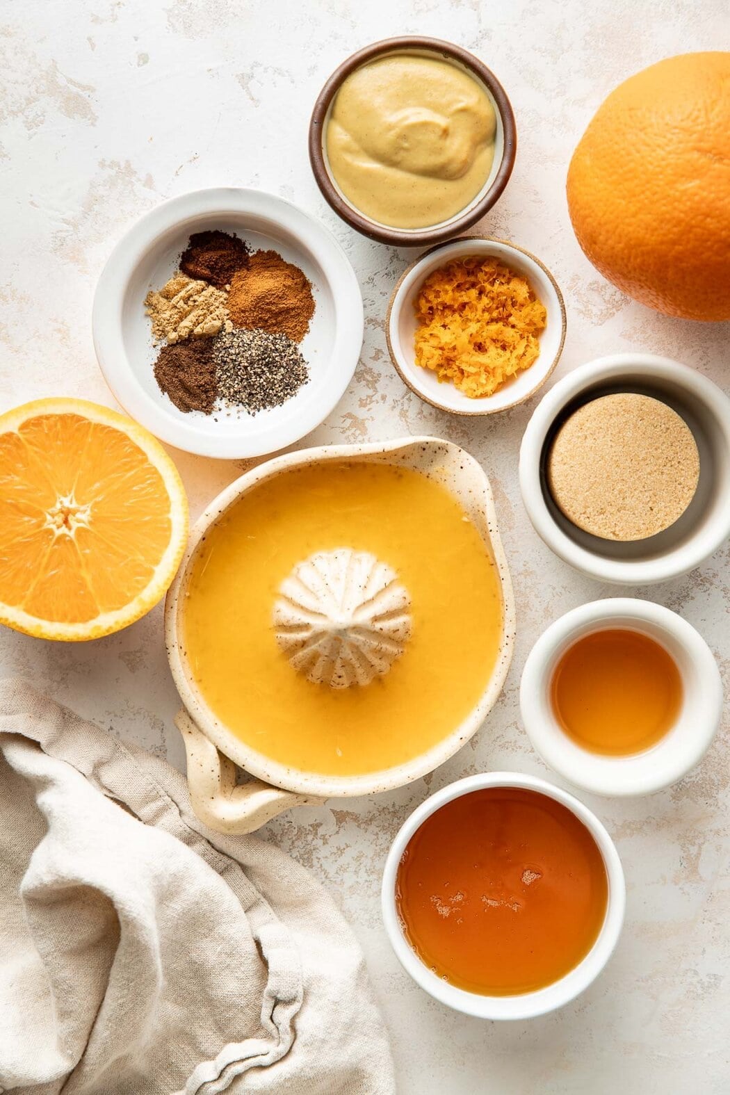 Overhead view of a variety of ingredients for Ham Glaze in different sized bowls.