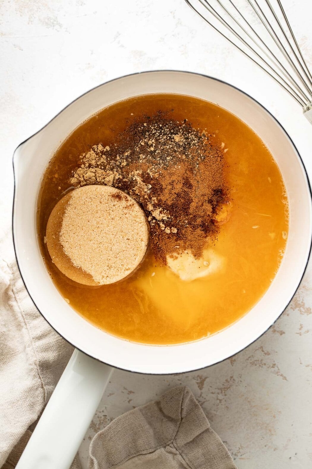 Overhead view of a small saucepan filled with Ham Glaze ingredients ready to be heated and stirred.