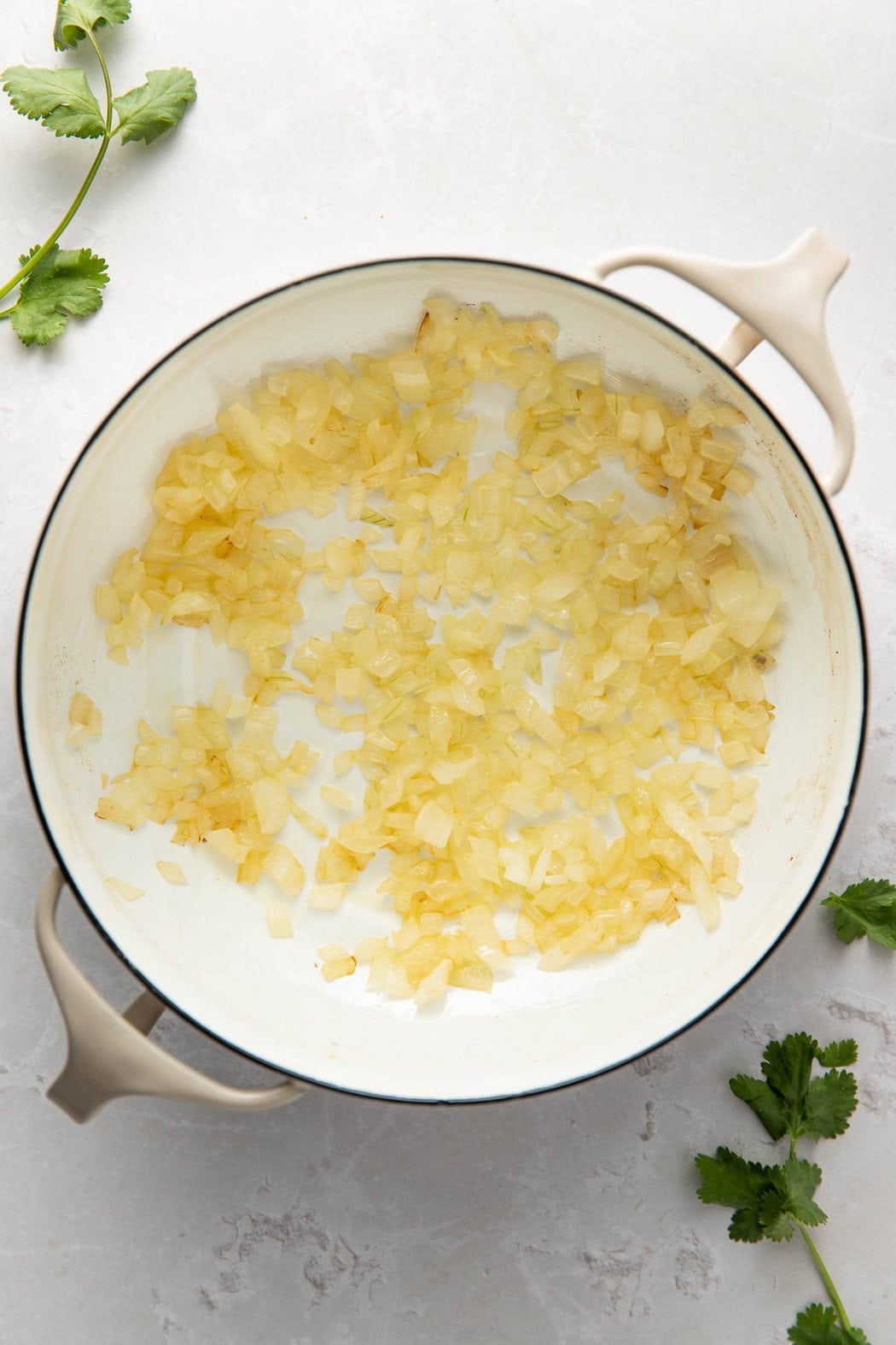 Overhead view of a skillet filled with chopped onions..