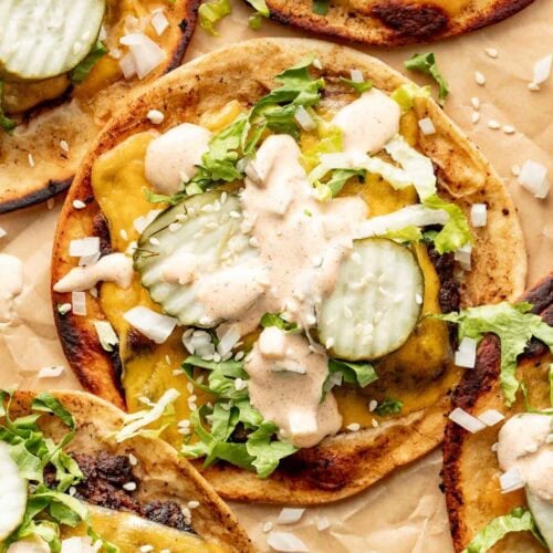 Overhead view of a Smash Burger Taco topped with special sauce and pickles.