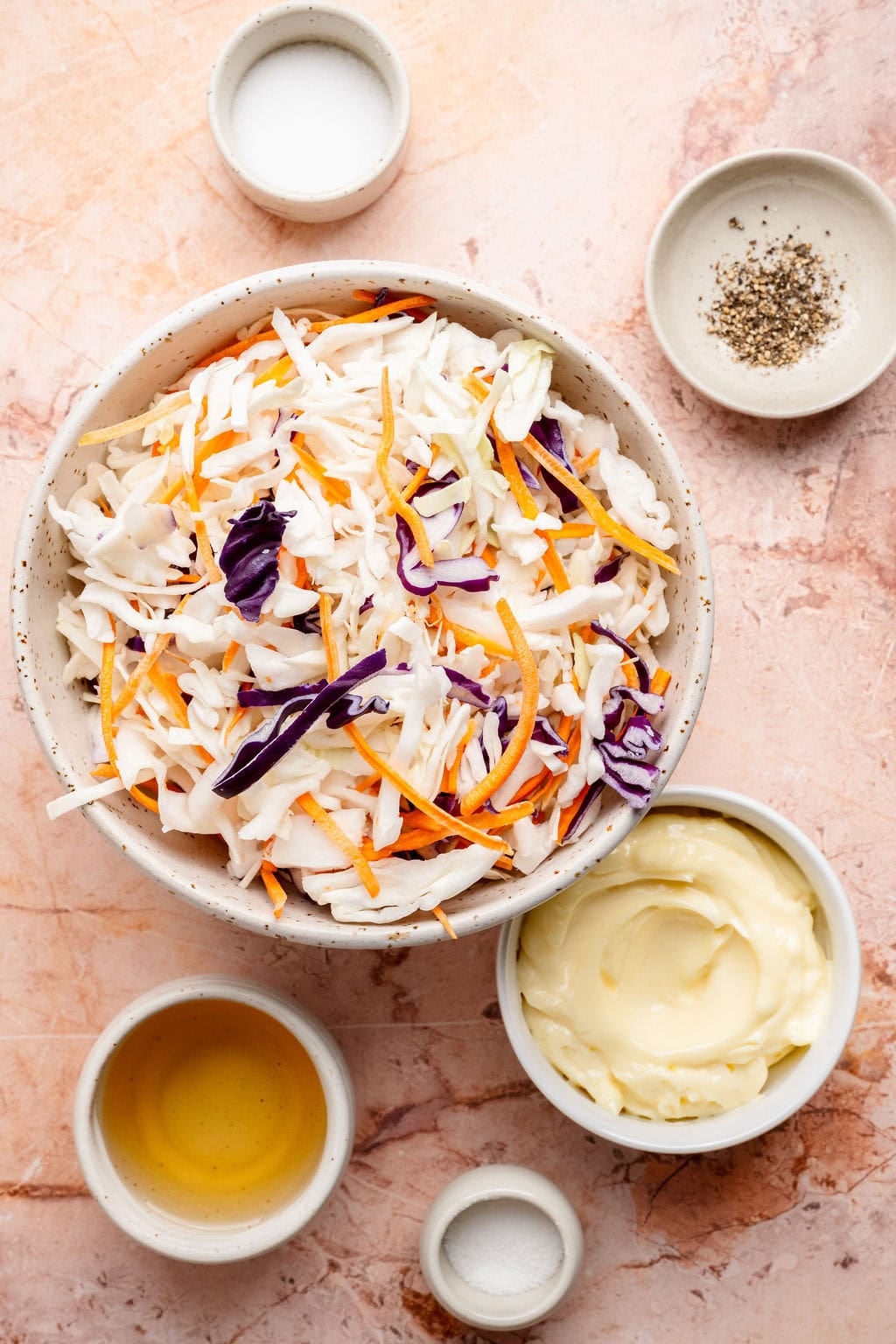 Overhead view of a variety of ingredients for coleslaw, including colorful cabbage blend.