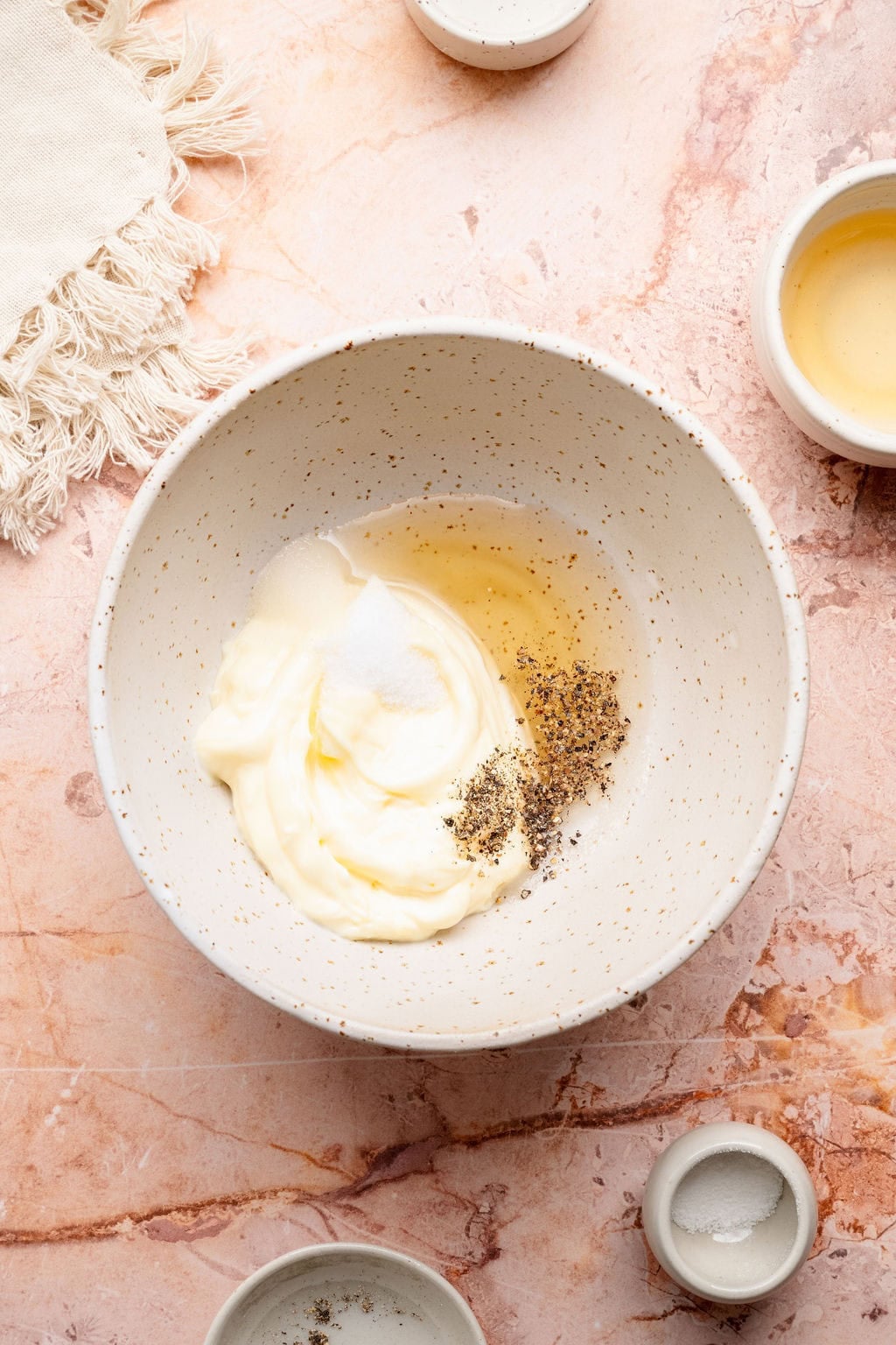 Overhead view of creamy dressing ingredients in a bowl for coleslaw.