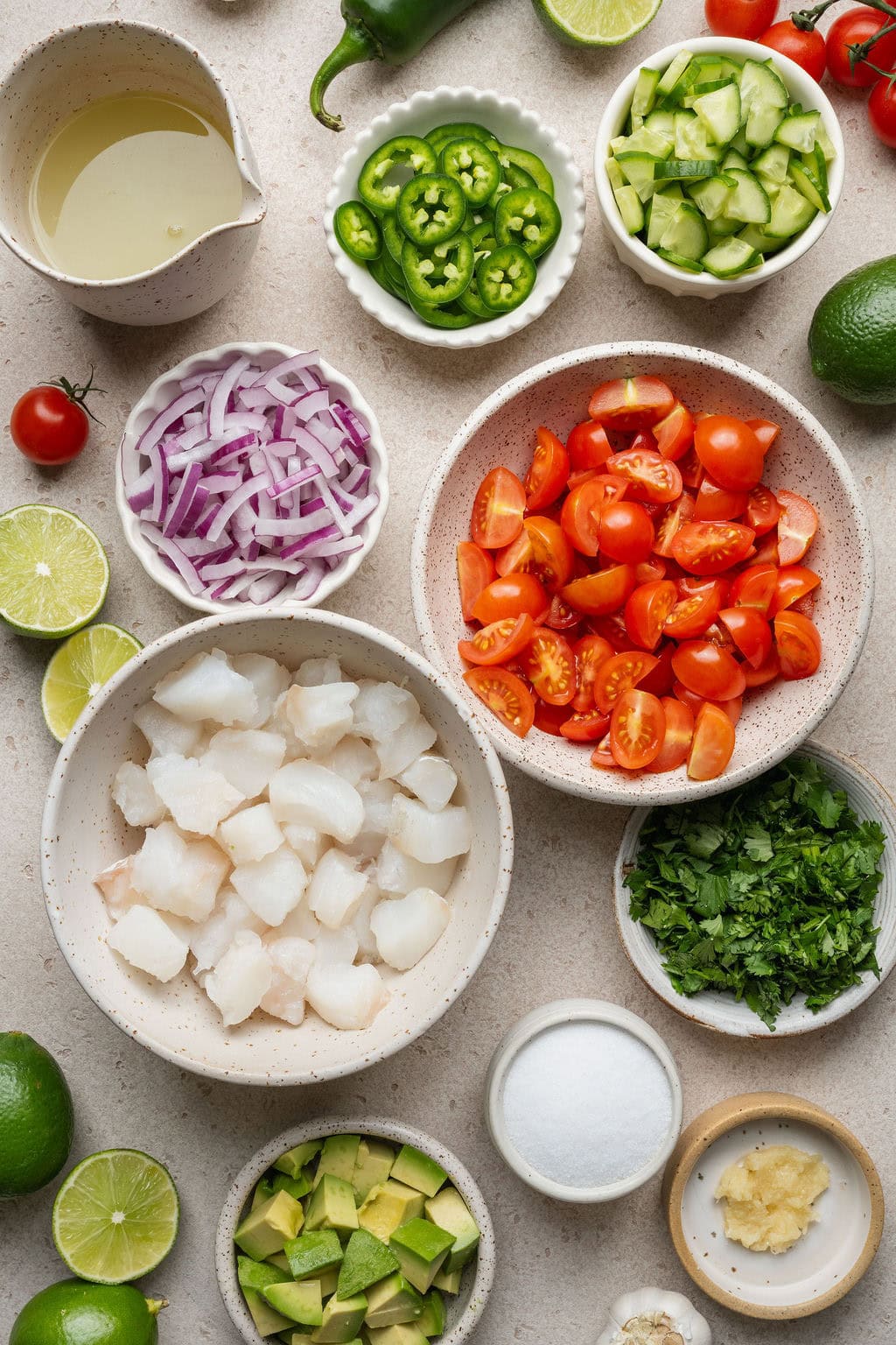 Overhead view of a variety of ingredients for Ceviche in different sized bowls. 