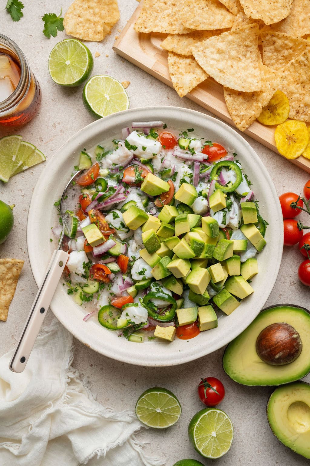 Overhead view of a bowl of fresh colorful Ceviche topped with diced avocado. 