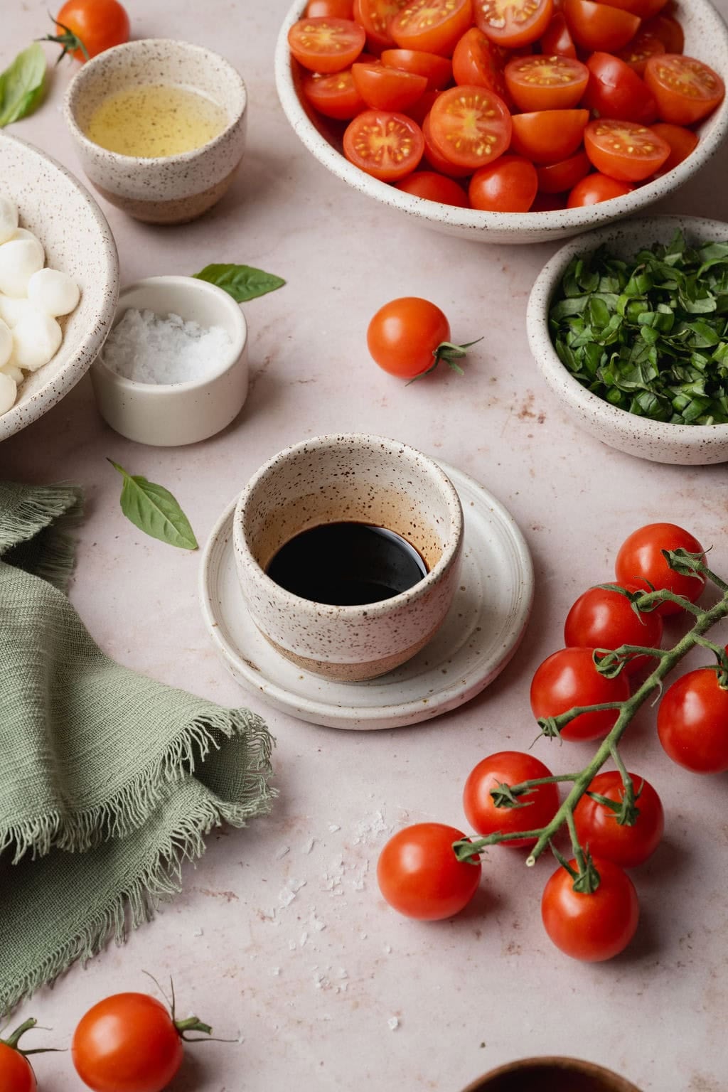 A small white speckled bowl of balsamic glaze.