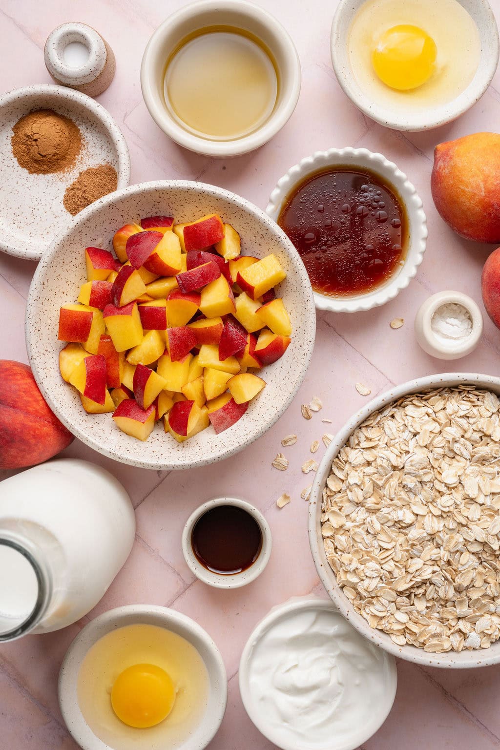 Ingredients to make peaches and cream baked oatmeal with fresh diced peaches.