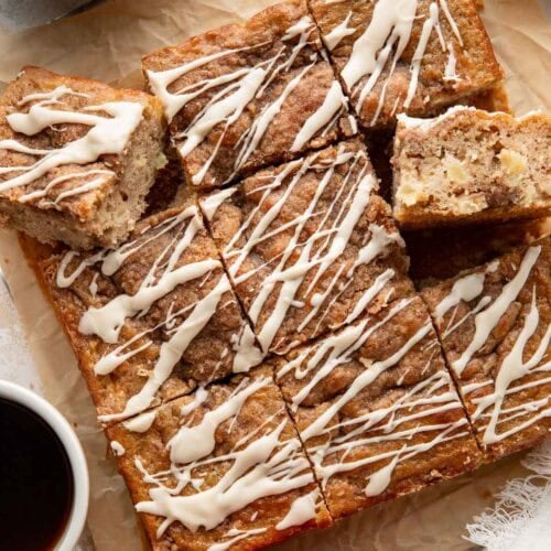 Squares of apple coffee cake topped with an icing drizzle.