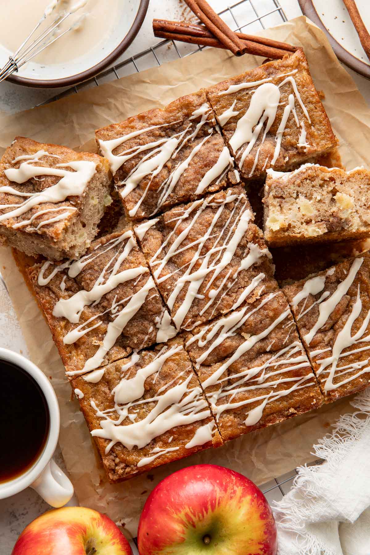 Squares of apple coffee cake topped with an icing drizzle.