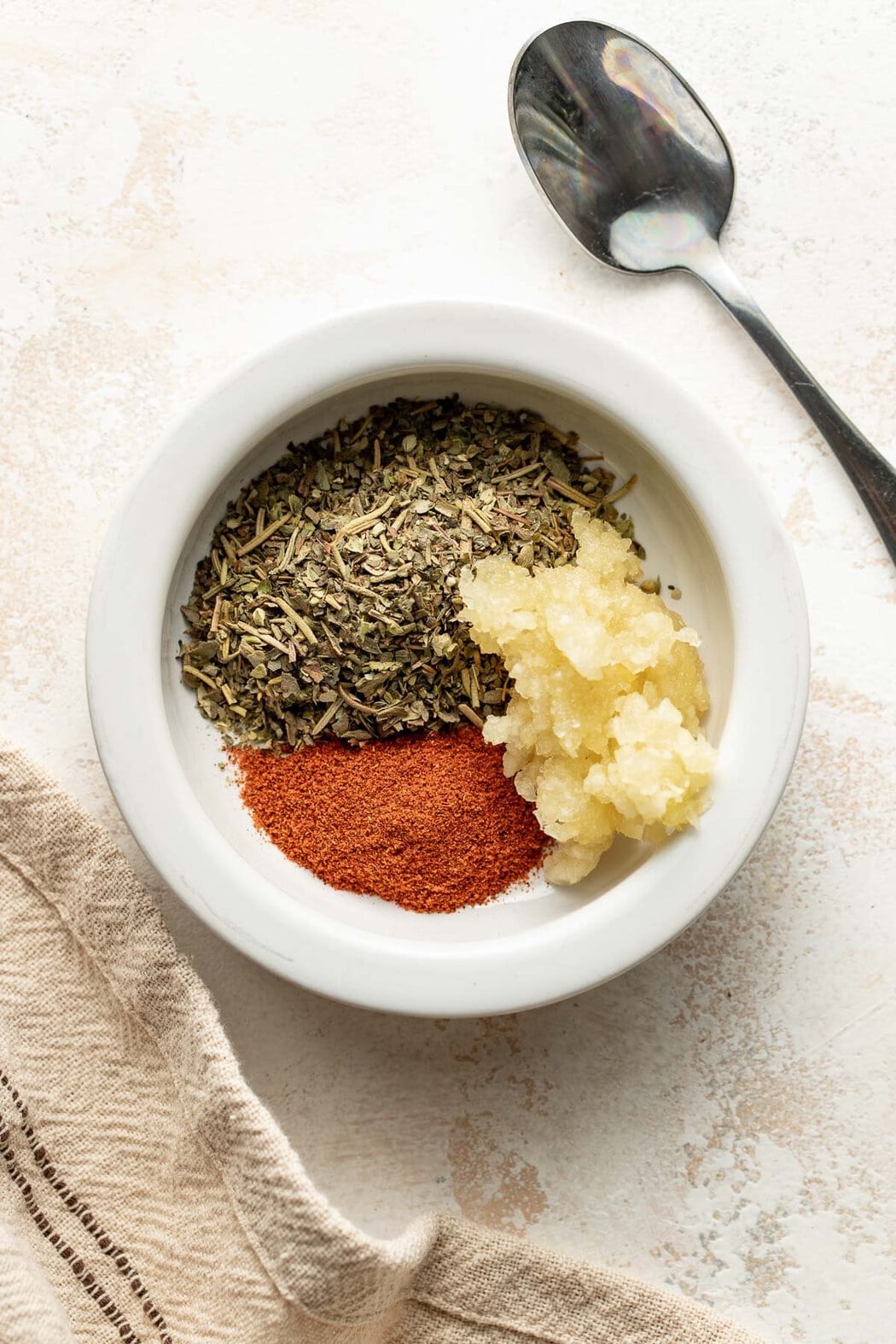 Ingredients for pork tenderloin rub in a small bowl.