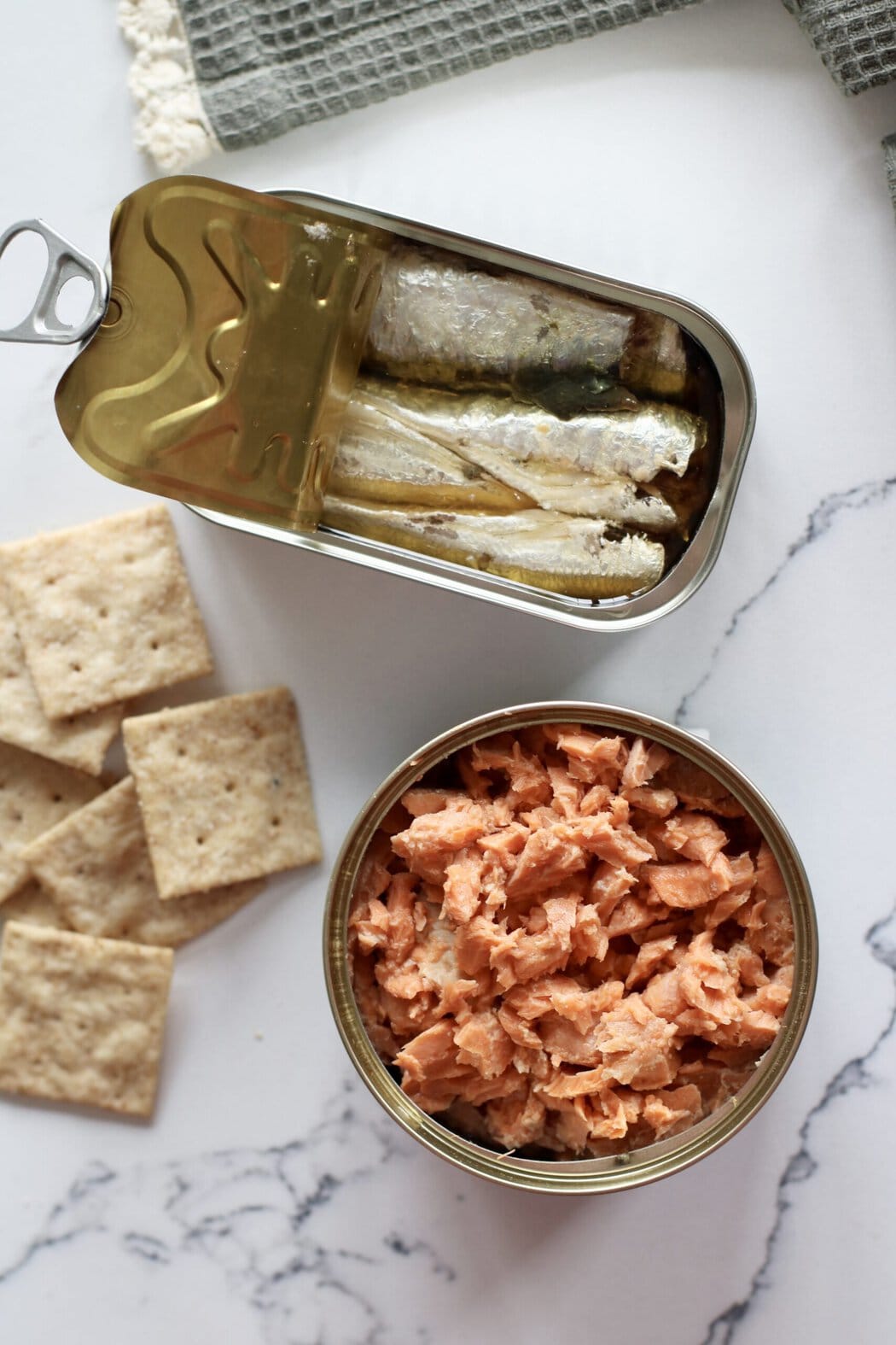 A tin of sardines, a can of tuna, and crackers.