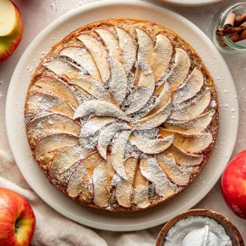 An apple cake topped with powdered sugar.