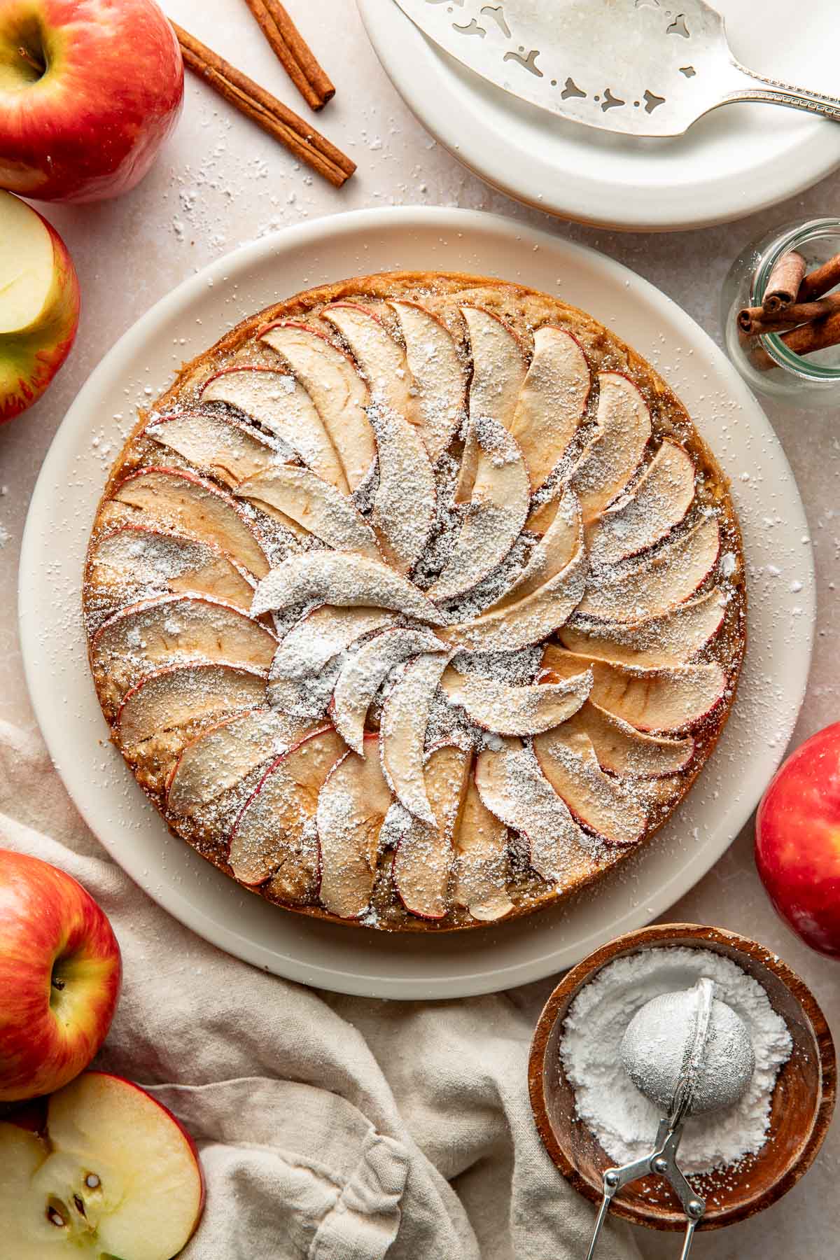An apple cake topped with powdered sugar.