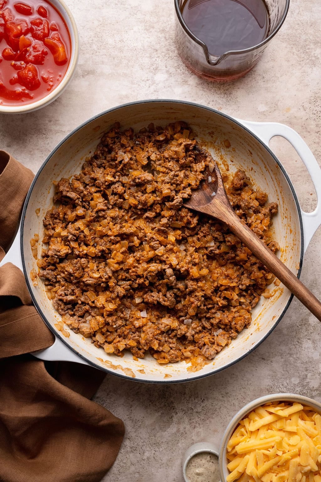 Seasoned ground beef and onions in a pot.