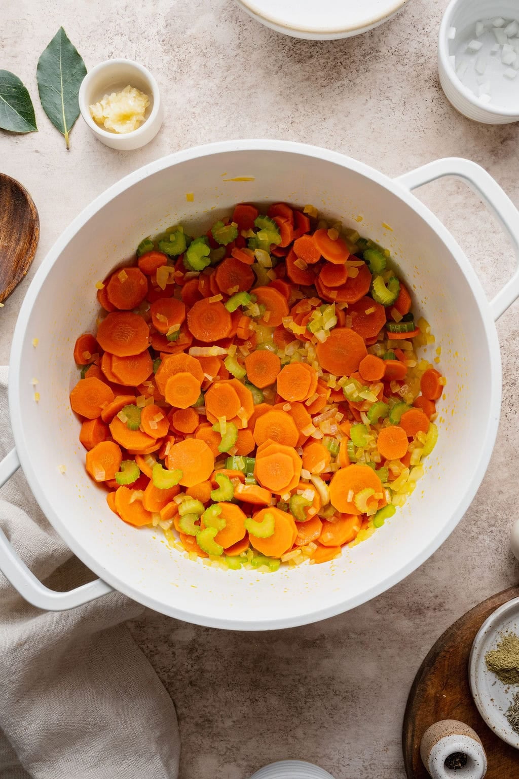 Carrots, celery, and onion cooking in a large pot.